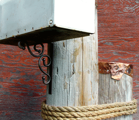 Mooring style wood mailbox support with scroll detail