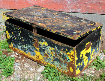 Metal footlocker or trunk with many coats of paint